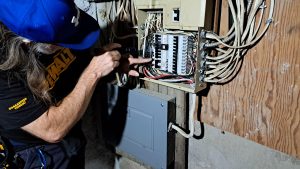 Home inspector in Kingston reviewing an electrical panel during a property inspection with Bill Stevenson, REALTOR® at Century 21 Lanthorn Real Estate Ltd.