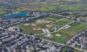 Aerial view of Woodbine Park in Bayridge, Kingston, showing baseball diamonds, soccer fields, and surrounding neighbourhood.