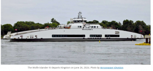 The Wolfe Islander IV ferry departs Kingston, Ontario, crossing Lake Ontario toward Wolfe Island.