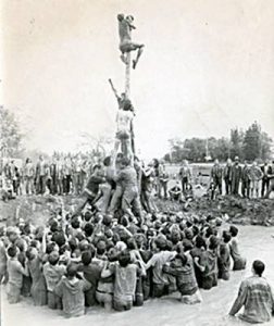 Frosh climbing the Queen’s grease pole, 1976
