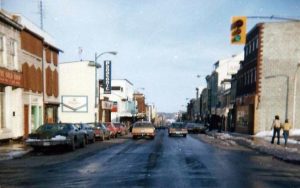 Princess Street in Kingston, Ontario during winter 1977, with cars parked along the snowy street