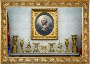 Overly ornate gold portrait frame and decorations — an example of niche design to avoid when preparing a home for resale