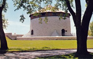 Vintage 1968 photograph of Murney Tower, a Martello tower in Kingston, Ontario, surrounded by trees and green lawns