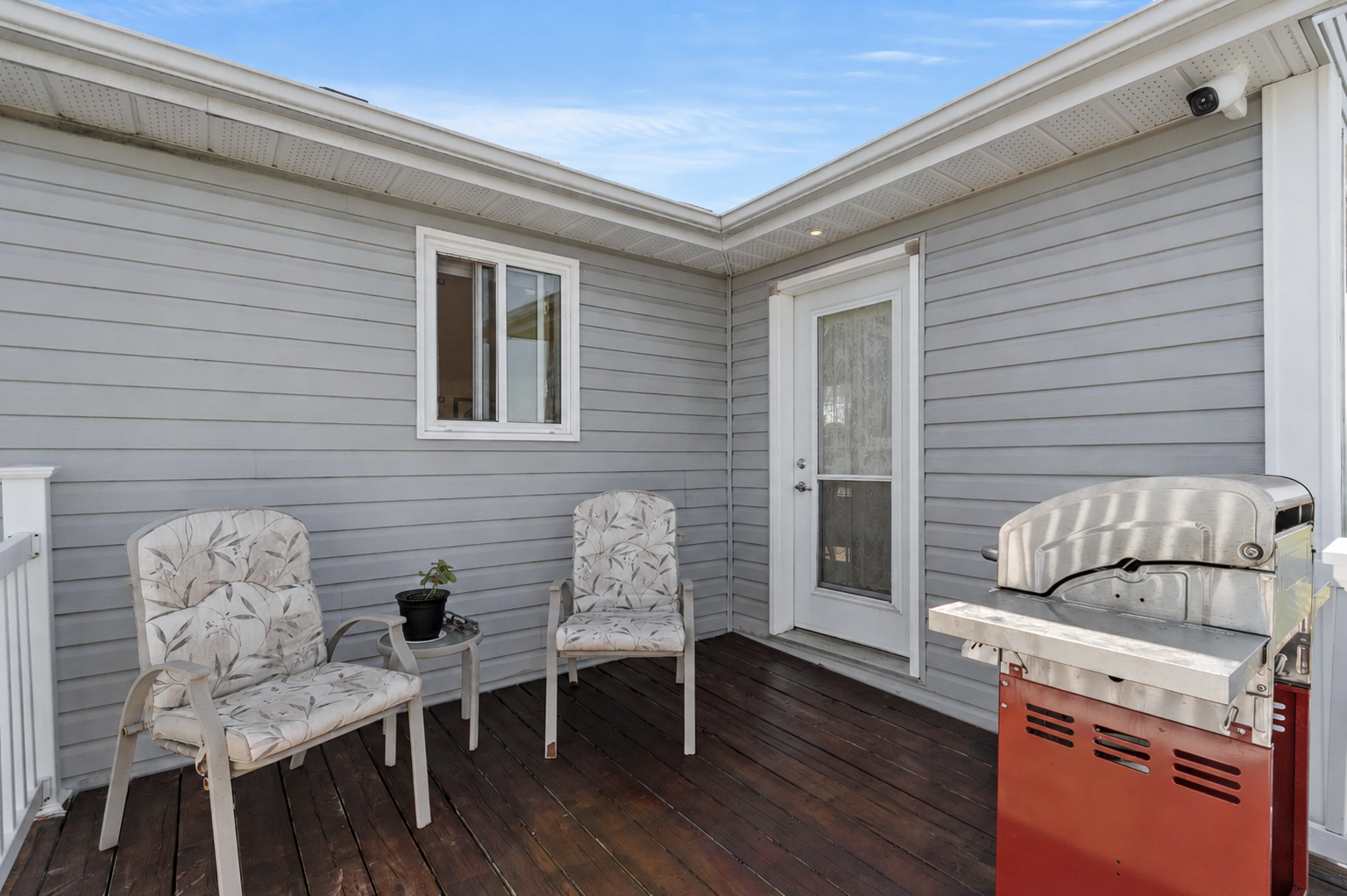 Bill Stevenson, REALTOR®, Century 21 Lanthorn Real Estate Ltd., Brokerage. Security camera mounted under the eaves monitoring a rear deck, patio door, and outdoor living space.