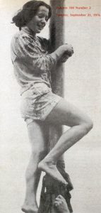 Female engineering student climbing the Queen’s Grease Pole during Frosh Week 1976, marking the first year women joined the tradition.
