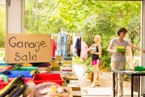 Garage sale items neatly displayed on tables in Kingston, branded for Century 21 Lanthorn Real Estate