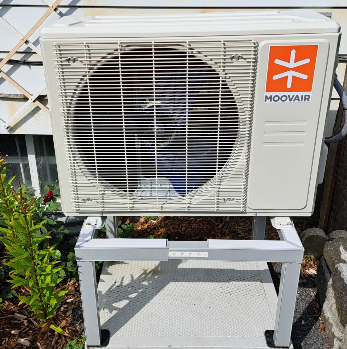 Outdoor cold-climate heat pump installed beside a home, illustrating a major mechanical system that affects long-term maintenance costs.