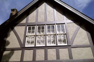 Freshly painted Tudor-style home exterior in Kingston with sharp trim and clean lines, showing how paint enhances curb appeal.