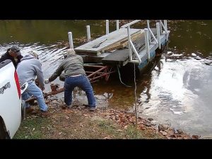 Homeowners removing a dock from the water during cottage closing season near Kingston — Bill Stevenson, REALTOR®, Century 21 Lanthorn Real Estate Ltd., Brokerage