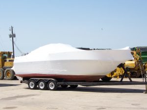Shrink-wrapped boat prepared for winter storage during cottage closing in Frontenac County near Kingston — Bill Stevenson, REALTOR®, Century 21 Lanthorn Real Estate Ltd., Brokerage.