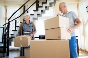 Senior couple packing boxes while downsizing their home in Kingston, Ontario
