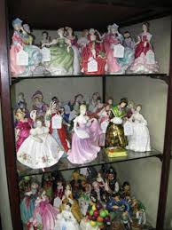 Glass cabinet filled with porcelain figurines, an example of collections to sort when downsizing a home in Kingston