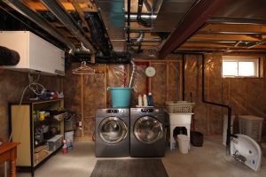 Unfinished Amherstview basement laundry area with exposed ductwork and studs.