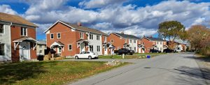 Row of military housing units near CFB Kingston under a bright autumn sky