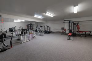 An exercise room in a Kingston condo with cardio machines and strength equipment, Bill Stevenson, REALTOR®, Century 21 Lanthorn Real Estate Ltd Brokerage