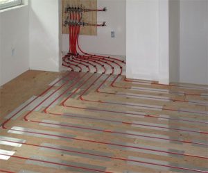 Radiant in floor heating installation with red hot water lines and a manifold, demonstrating how tubing runs throughout the floor in many Kingston area homes, Bill Stevenson REALTOR, Century 21 Lanthorn Real Estate Ltd, Brokerage