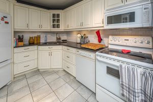 A bright renewed kitchen in a Kingston condo with updated cabinets, tile flooring, and modern finishes, Bill Stevenson REALTOR, Century 21 Lanthorn Real Estate Ltd Brokerage
