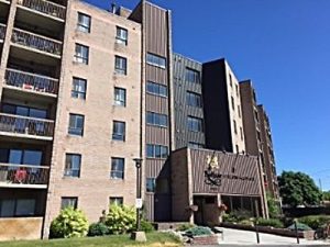 A starter condo building in Kingston with balconies and a landscaped entrance, Bill Stevenson, REALTOR®, Century 21 Lanthorn Real Estate Ltd Brokerage