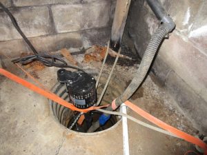 Sump pump installed in an open basement pit managing groundwater around a Kingston home foundation, Bill Stevenson, REALTOR®, Century 21 Lanthorn Real Estate Ltd., Brokerage