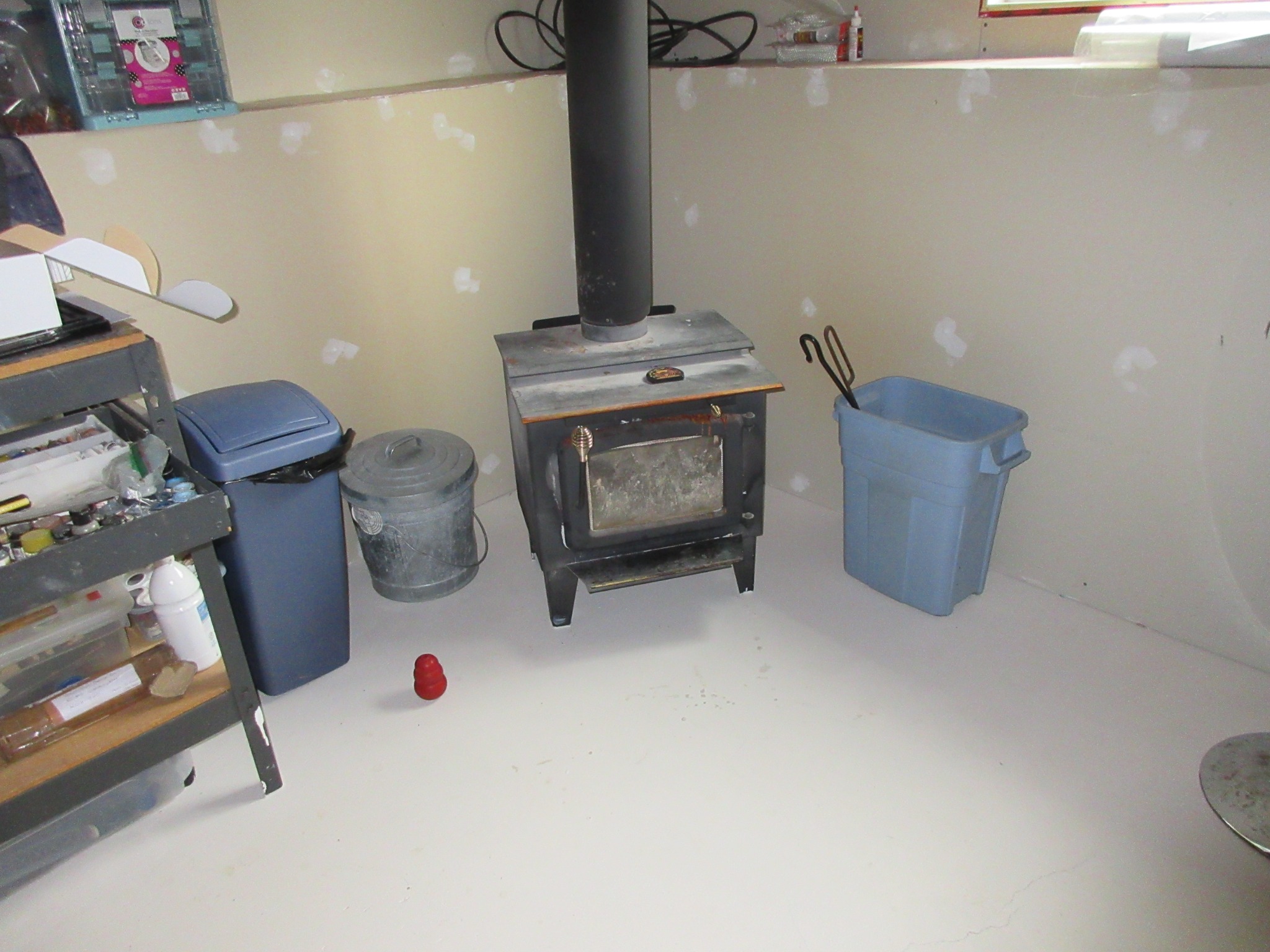 Wood stove installation with potential heat shield and clearance concerns in a Kingston area home