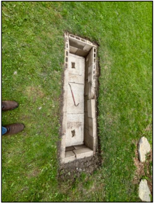 Septic system access chamber uncovered during a Kingston area home inspection, showing required maintenance concerns