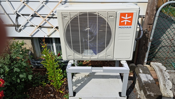 Eco-friendly Air source heat pump outdoor unit installed at Kingston Ontario home showing energy efficient heating system