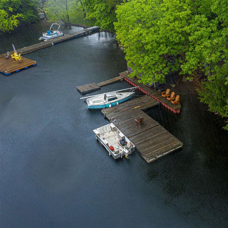 Multiple docks and boats on waterfront property in Kingston area showing access and usage, Bill Stevenson REALTOR® Century 21 Lanthorn Real Estate Ltd Brokerage