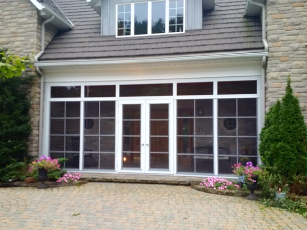 home entrance with stone exterior, walkway, and spring landscaping for curb appeal