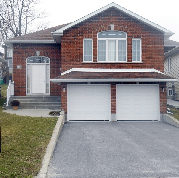 Two storey brick suburban home in Kingston Ontario illustrating a typical residential property Bill Stevenson REALTOR® Century 21 Lanthorn Real Estate Ltd Brokerage
