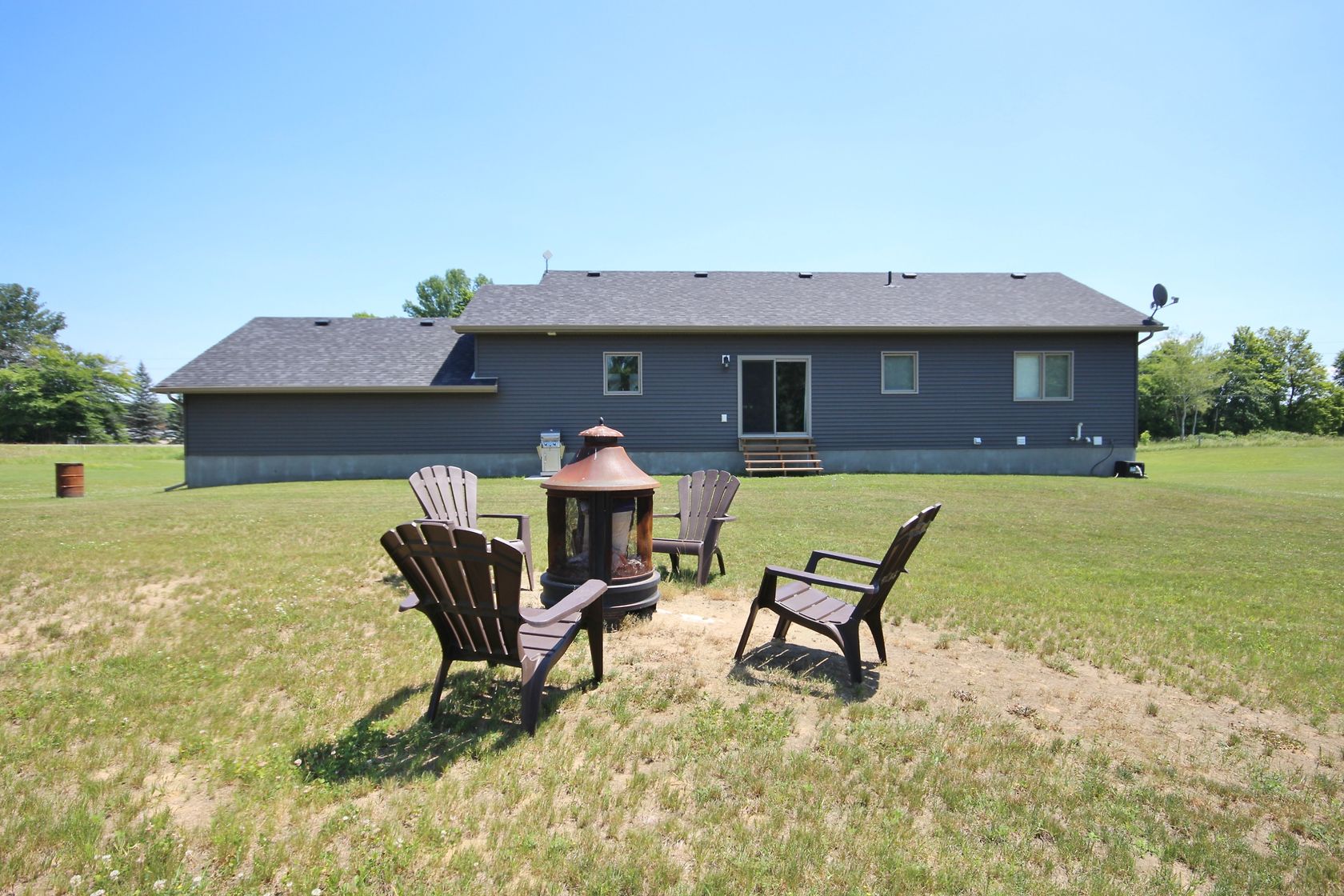 Moving for more space. Rural backyard with fire pit and seating area north of Kingston Ontario