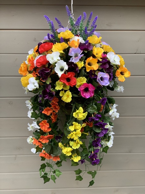 Colourful spring hanging basket with vibrant flowers enhancing curb appeal at a Kingston home entrance