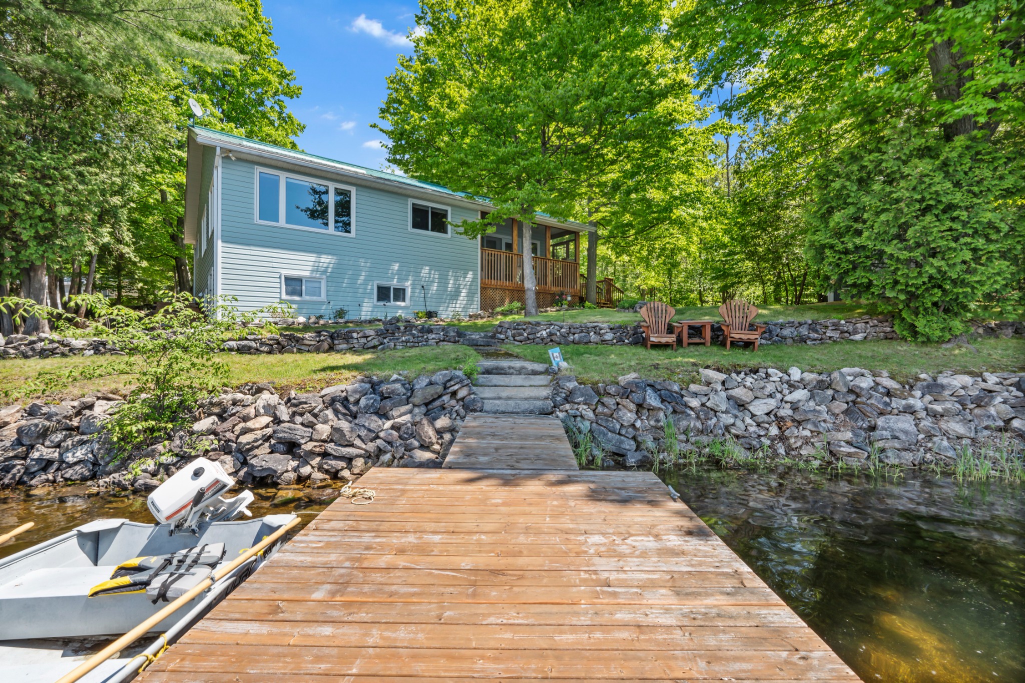 Year-round waterfront home with shoreline and seating area in Kingston area, Bill Stevenson REALTOR® Century 21 Lanthorn Real Estate Ltd Brokerage