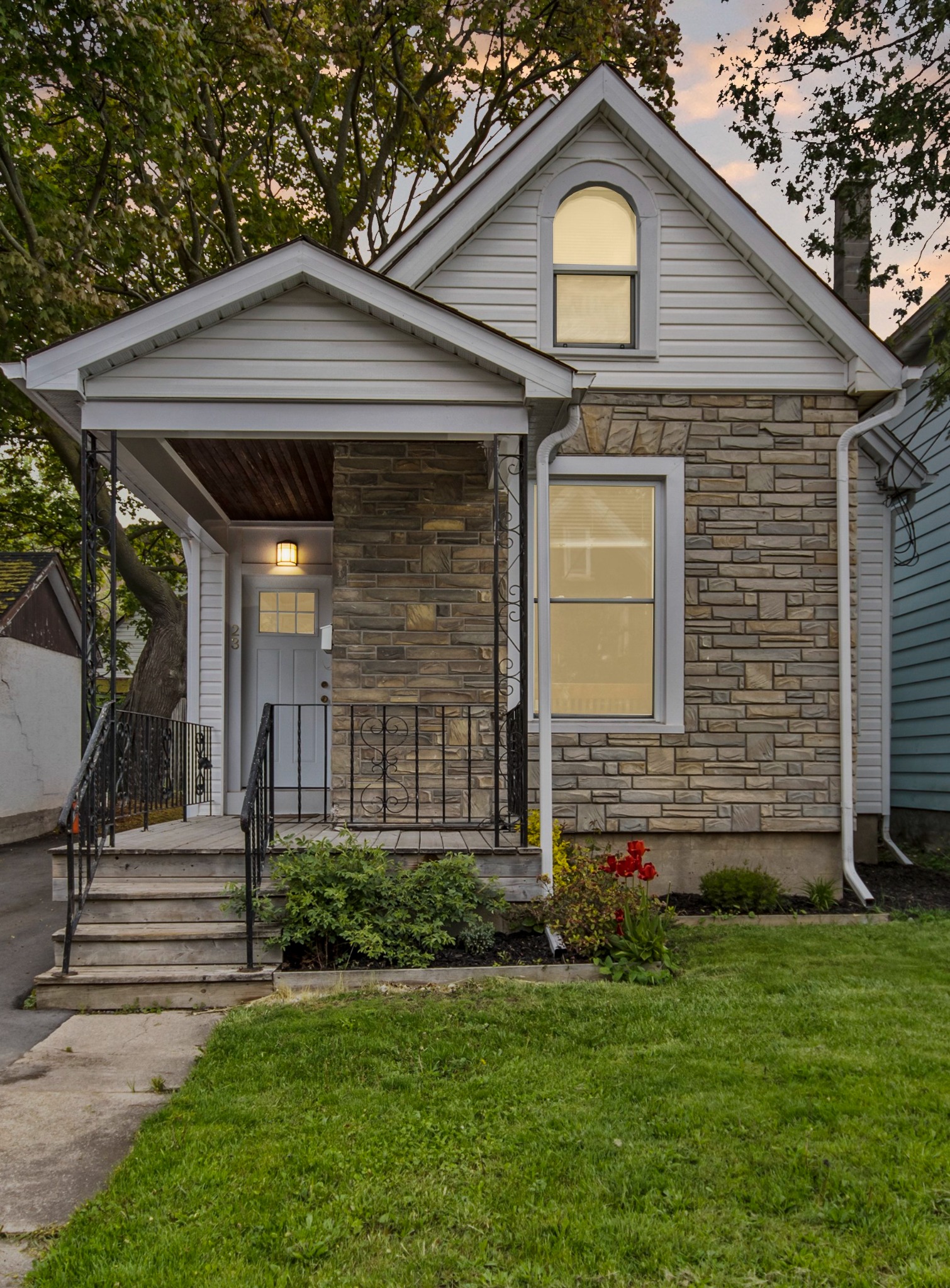 Bill Stevenson REALTOR® single family home exterior with stone facade and covered front porch in Kingston Ontario, March 2026
