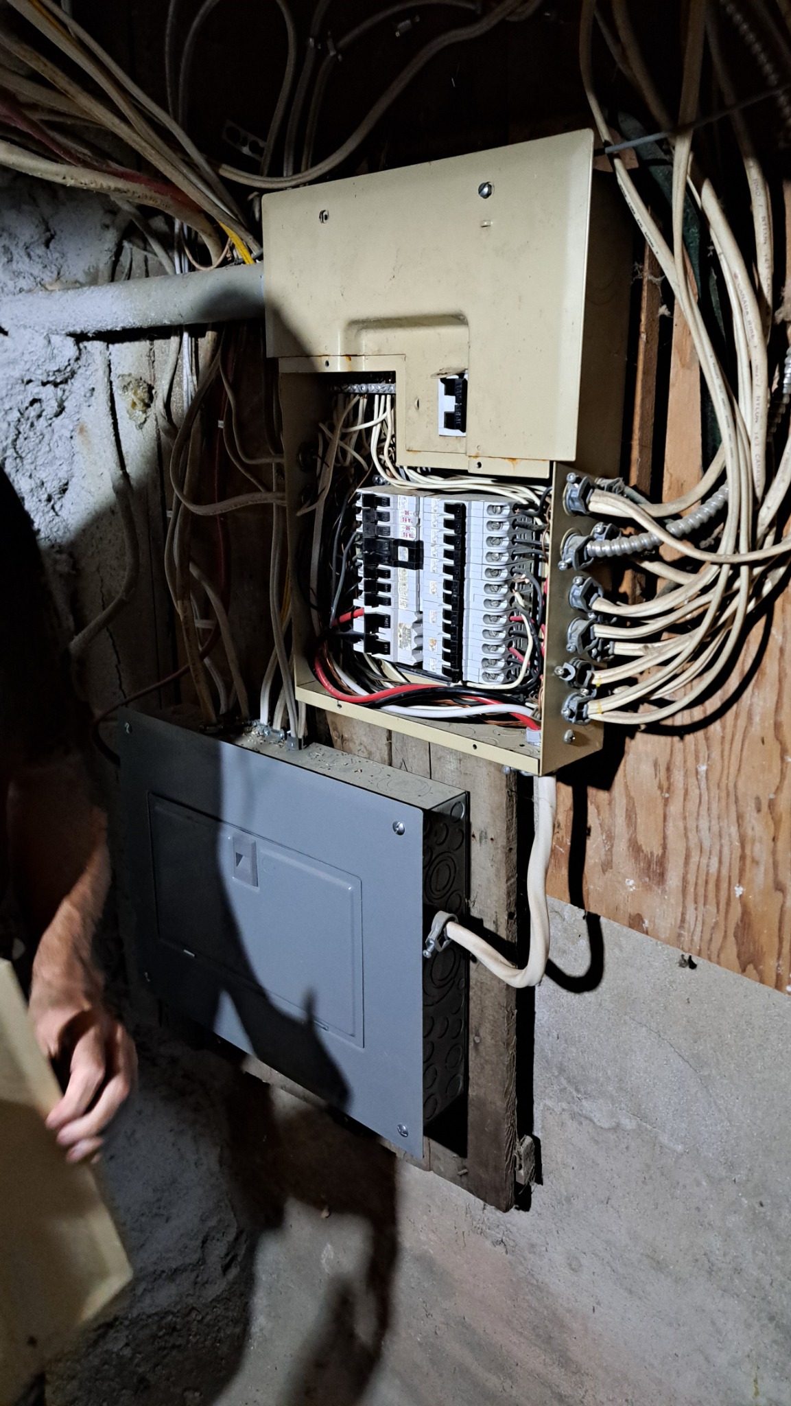 Home inspector examining electrical panel during property inspection