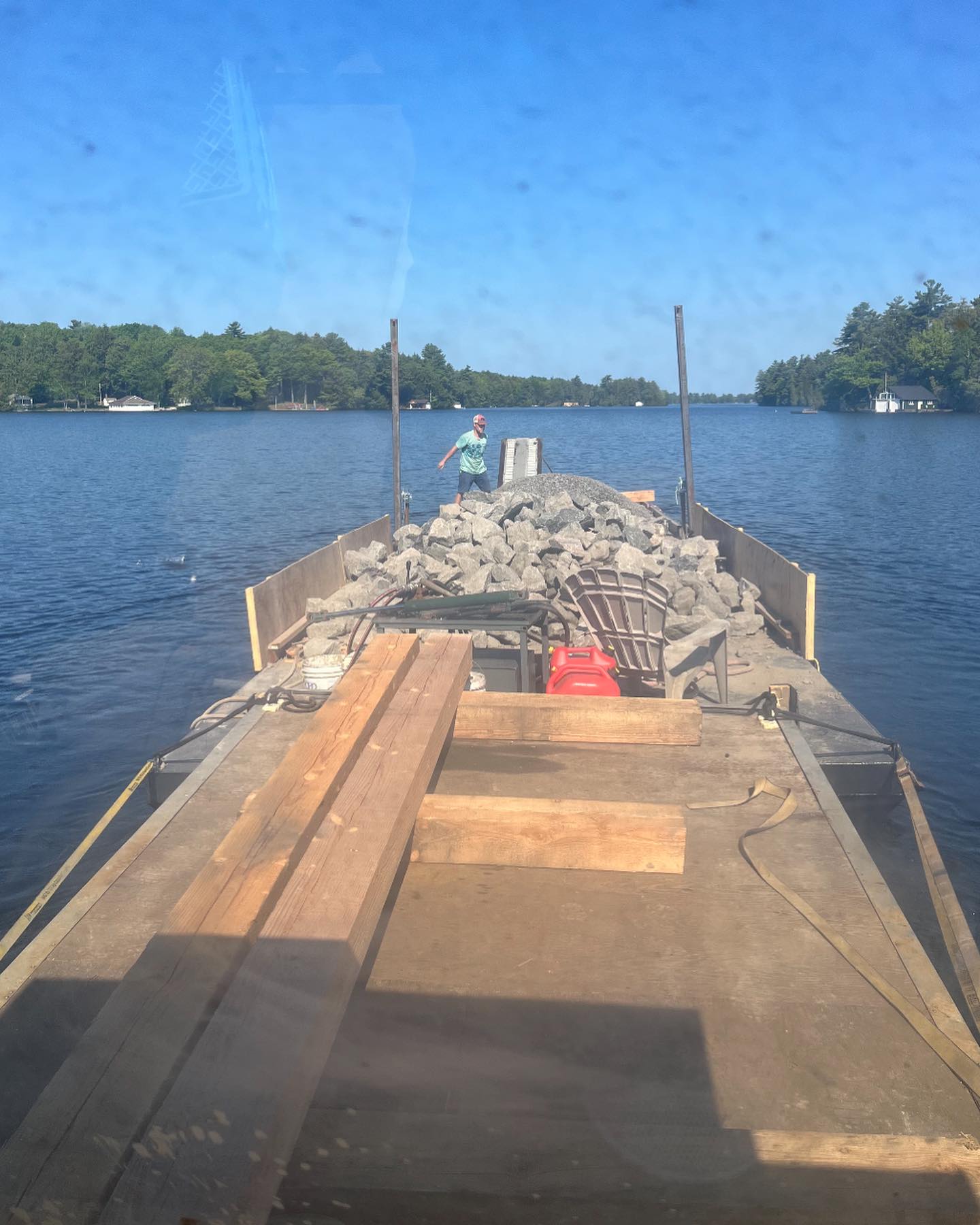 building materials delivered by barge to a vacant land waterfront property Ontario construction site access