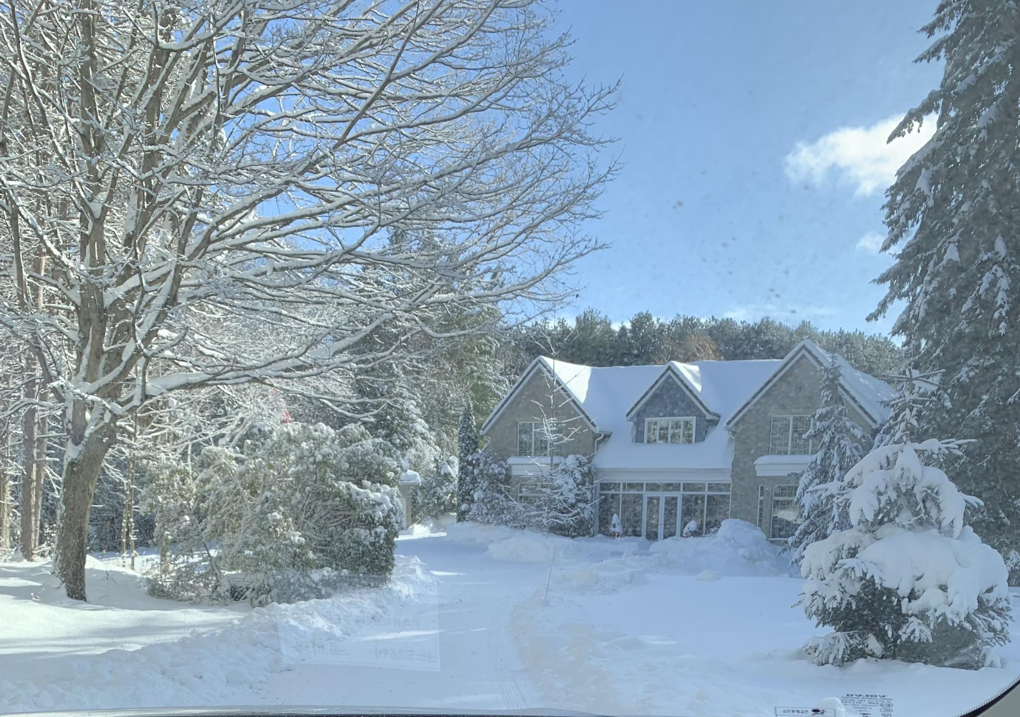 Snow-covered home in Kingston area showing winter curb appeal, driveway access, and roof snow load conditions