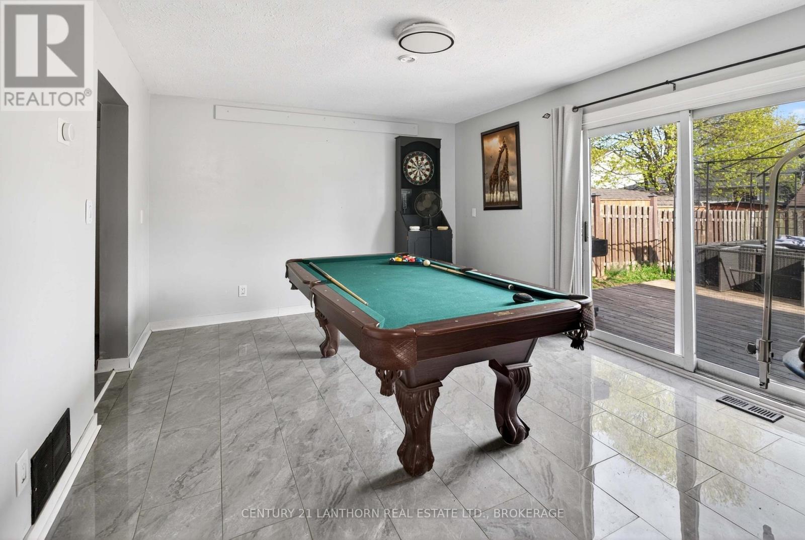 Recreation room with pool table and backyard access in Amherstview family home