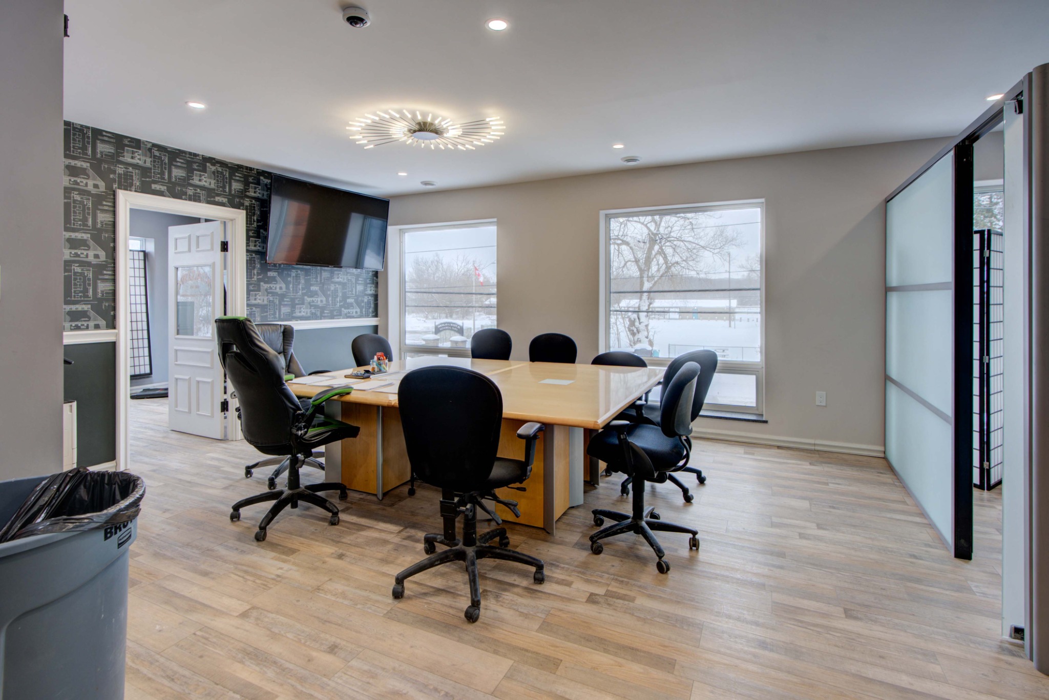 Modern boardroom and collaborative office workspace with large meeting table and contemporary finishes.
