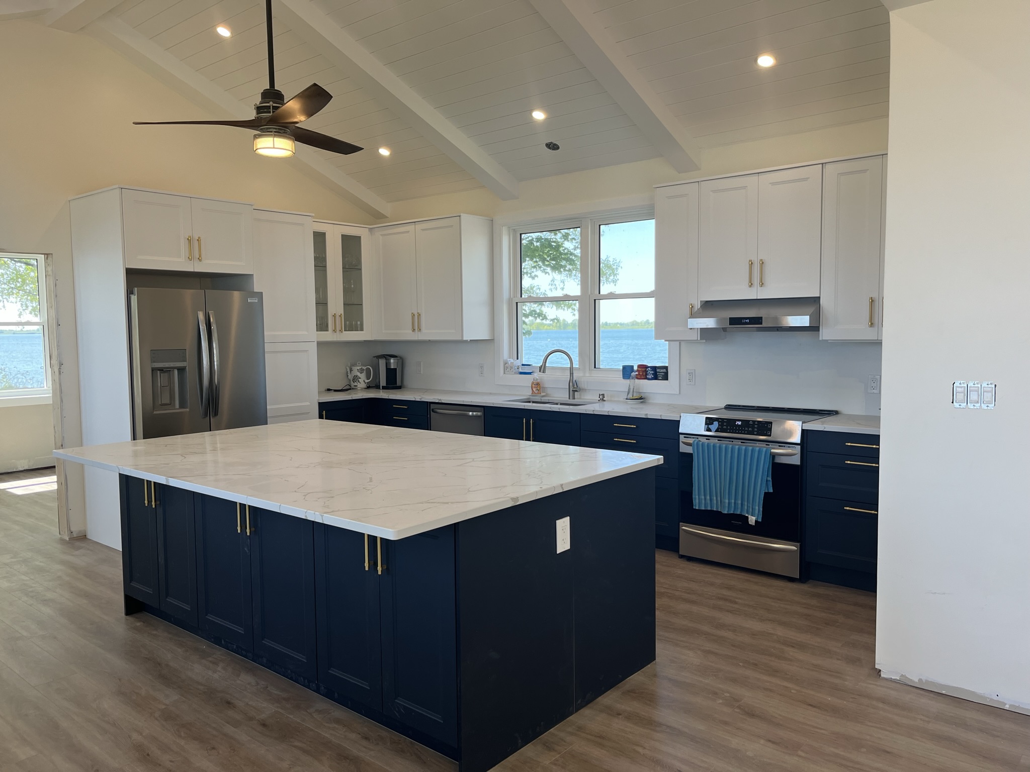 Kingston area homes priced $900K-$1.5M featuring an executive kitchen with luxury finishes and waterfront views