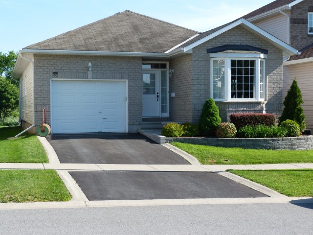 Newer bungalow style home in Kingston East Greenwood Park neighbourhood with driveway and garage showing affordable housing options for buyers Bill Stevenson REALTOR® Century 21 Lanthorn Real Estate Ltd Brokerage