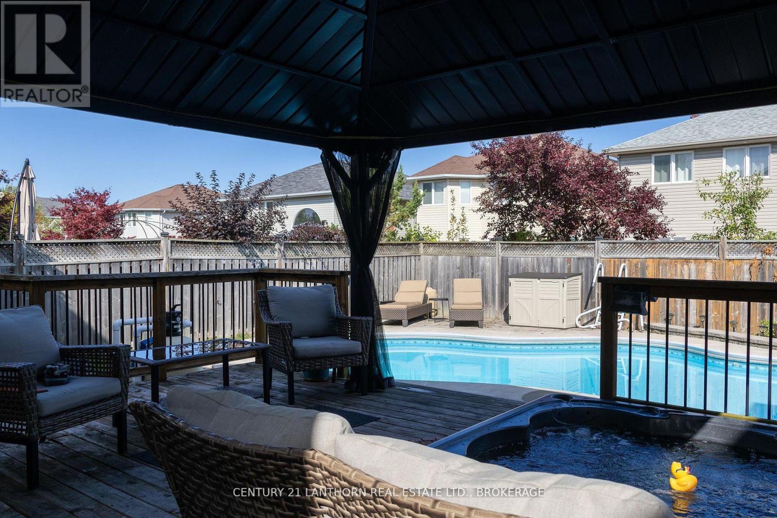 Luxury backyard with heated inground pool and covered hot tub in King's landing family home