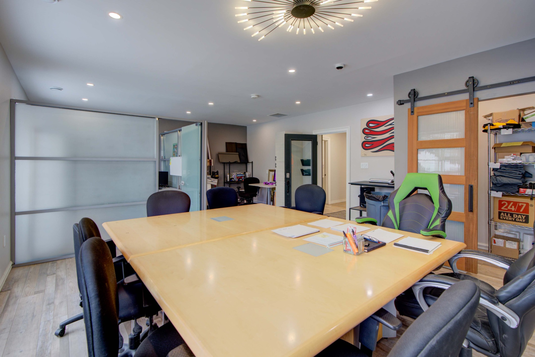 Modern office boardroom with collaborative workspace, sliding doors, and contemporary commercial finishes.
