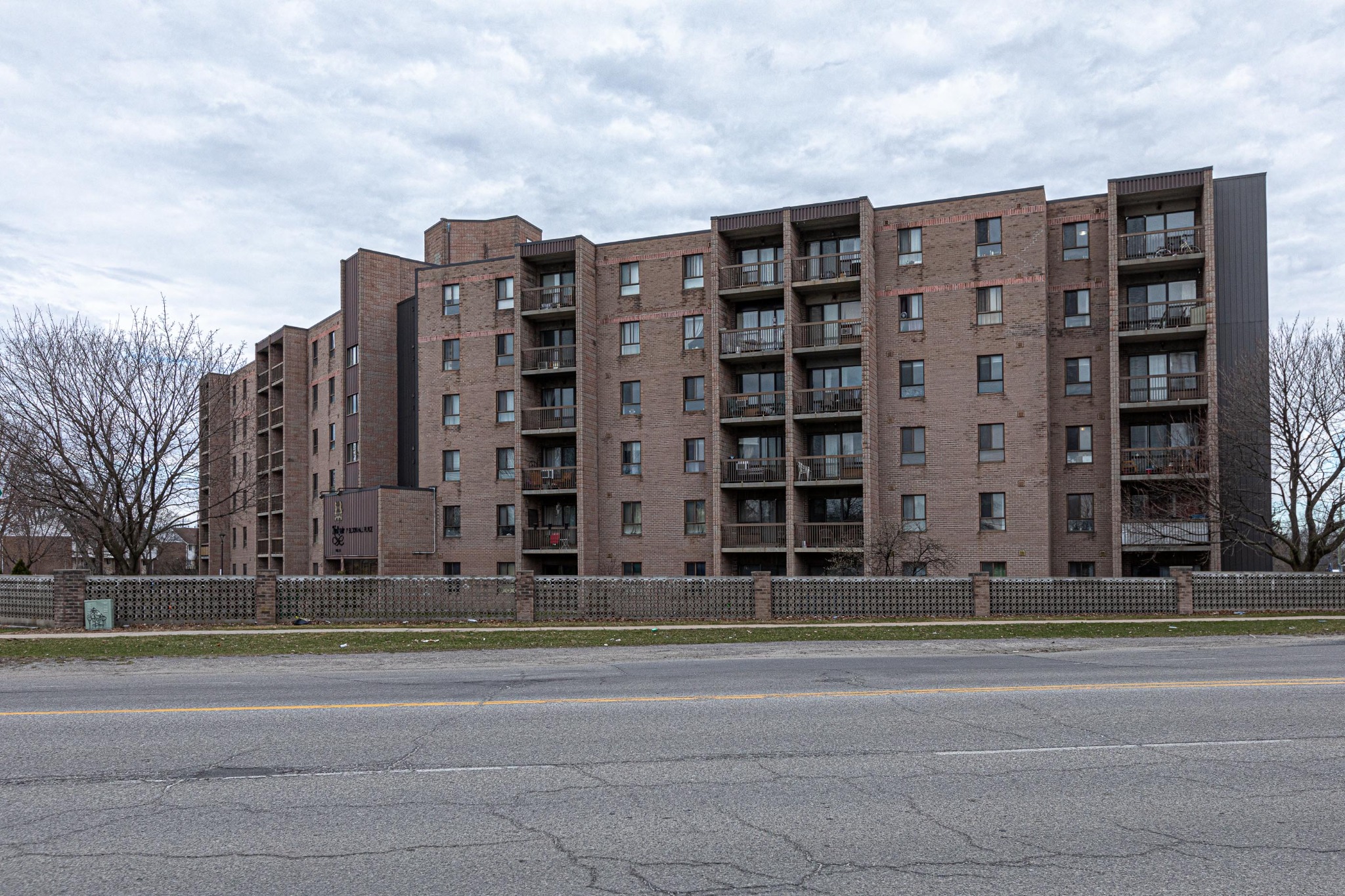 Older multi-storey condominium building in Kingston Ontario representing lower-priced condo options with fewer amenities