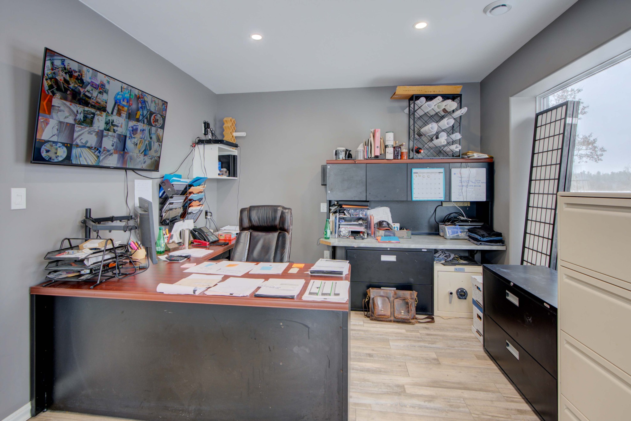 Private office workspace with desk, storage, and natural light within second floor office space for lease.