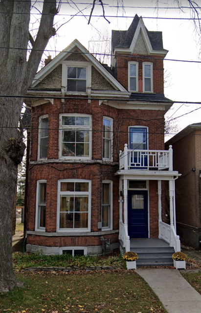 Many students finf themselves moving to Kihston: Historic brick home near Queen’s University in Kingston Ontario showing heritage architecture and downtown residential living