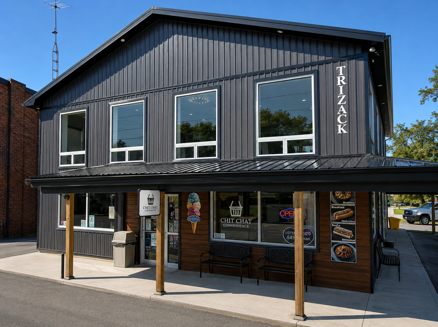 Exterior view of modern walk-up second floor office space for lease above commercial retail units.