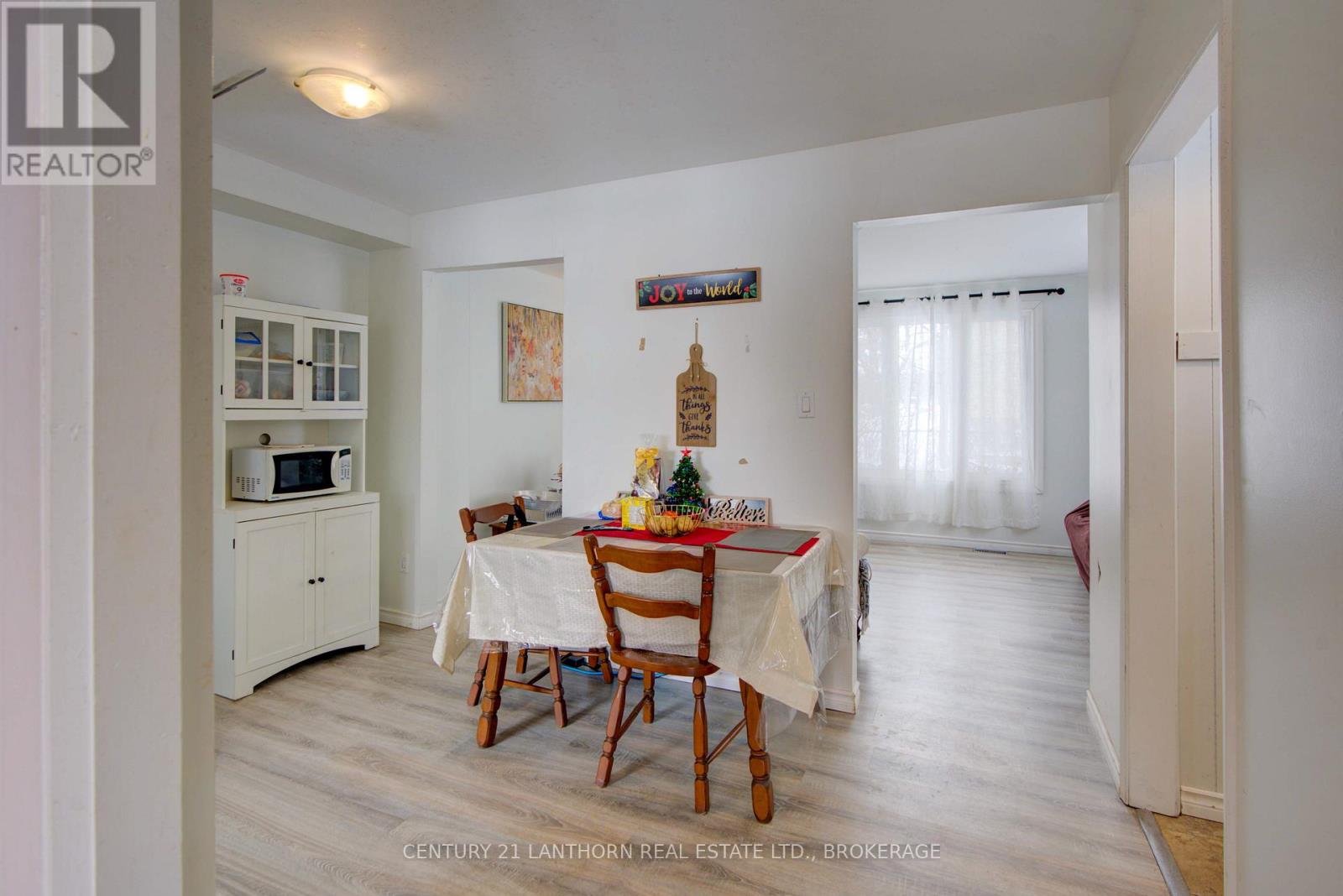 Dining area at 6 Woodstone Crescent in Kingston with updated flooring, bright natural light, and an open connection to the main living spaces. Bill Stevenson, REALTOR®, Century 21 Lanthorn Real Estate Ltd., Brokerage.