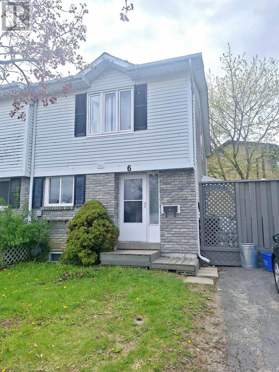 Front exterior of 6 Woodstone Crescent in Kingston, Ontario, a semi-detached home with private driveway, mature trees, and landscaped front yard. Bill Stevenson, REALTOR®, Century 21 Lanthorn Real Estate Ltd., Brokerage.