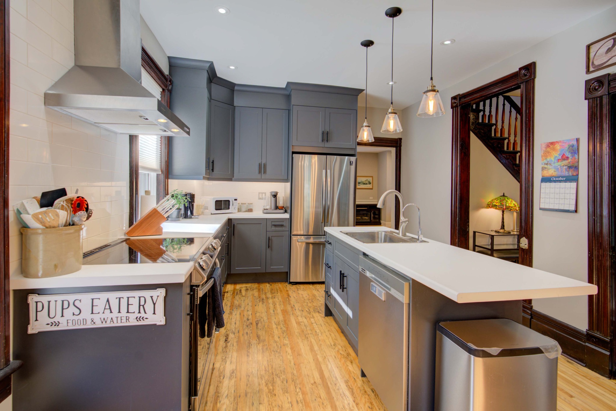 Custom kitchen with quartz island in the restored century home at 2 John Street, Delta