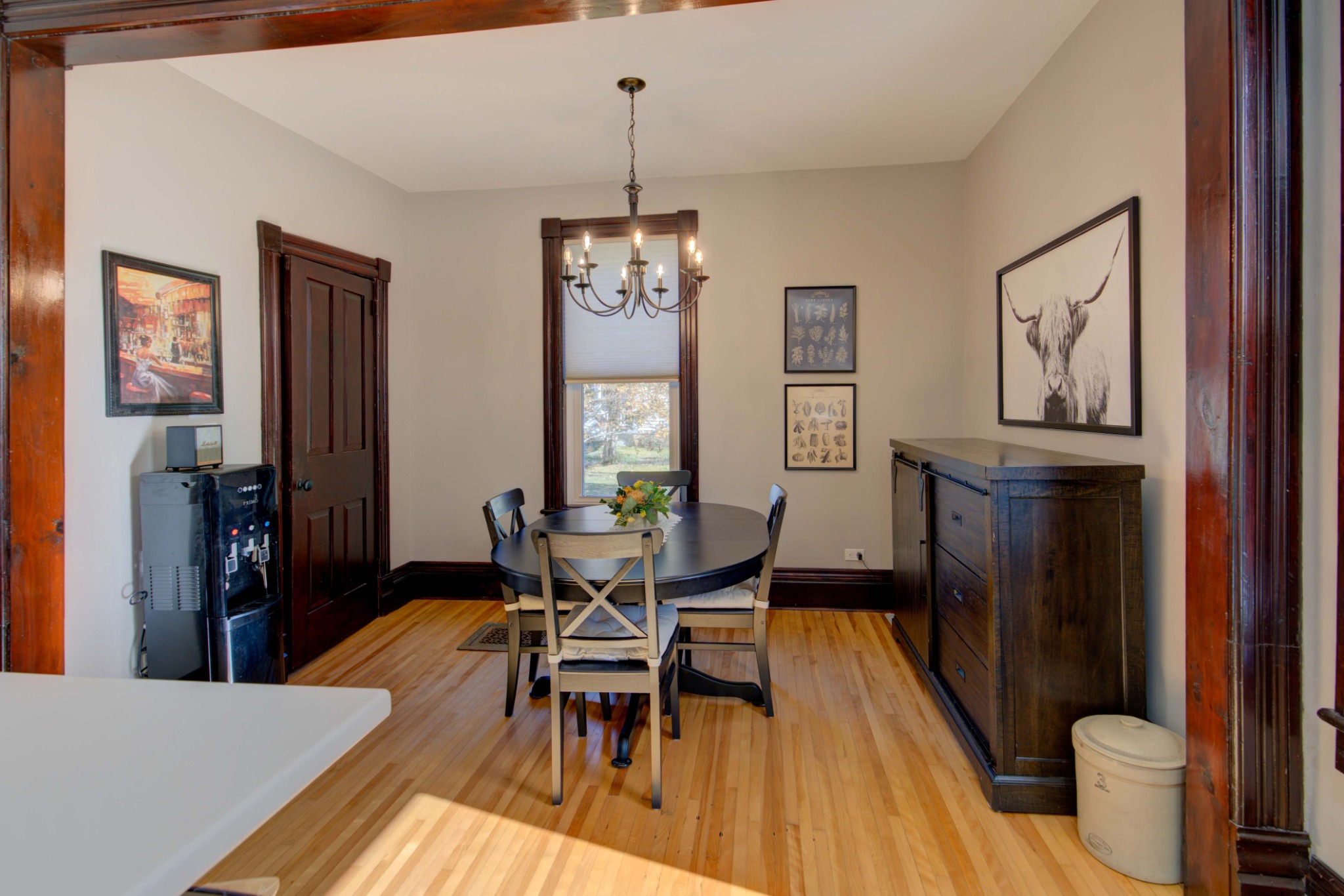 Formal dining room with original hardwood floors and wood trim at 2 John Street in Delta